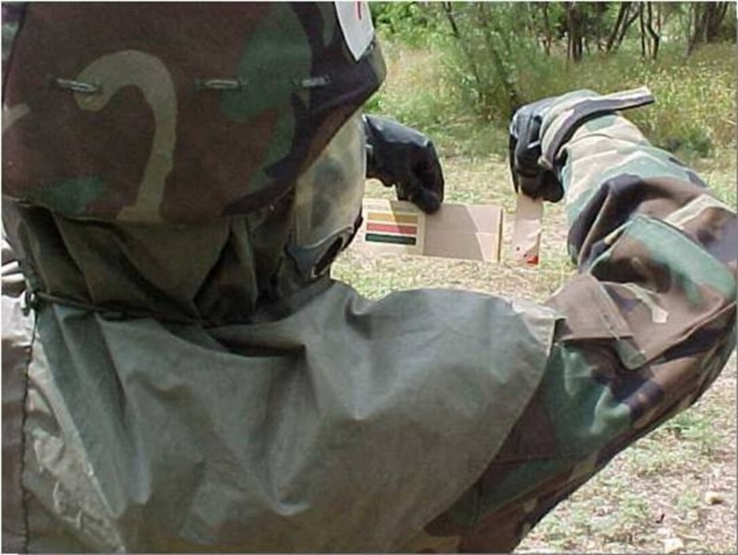 Soldier using M8 paper to test for chemical agents