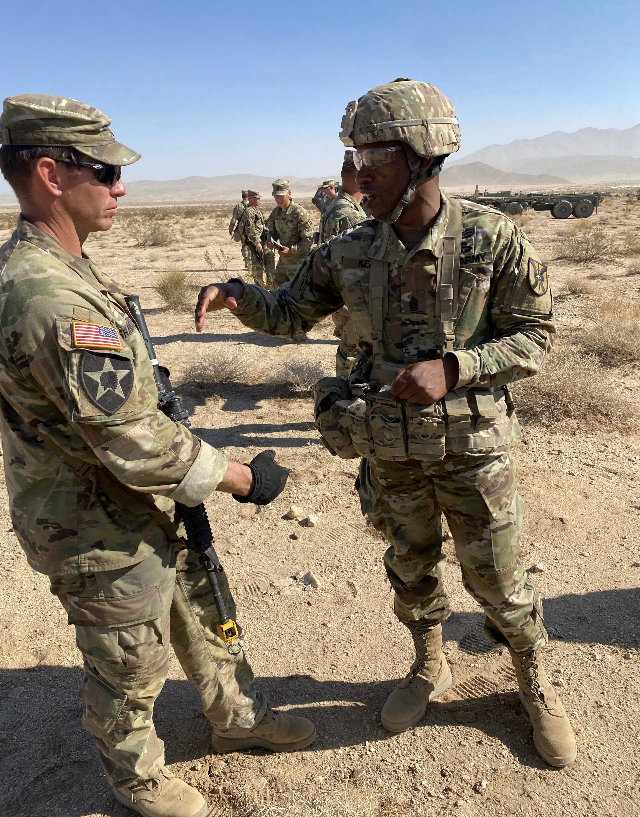 CSM Montrell L. Kea talks about CLIX distribution with an NCO from a rotational training unit at the National Training Center. 